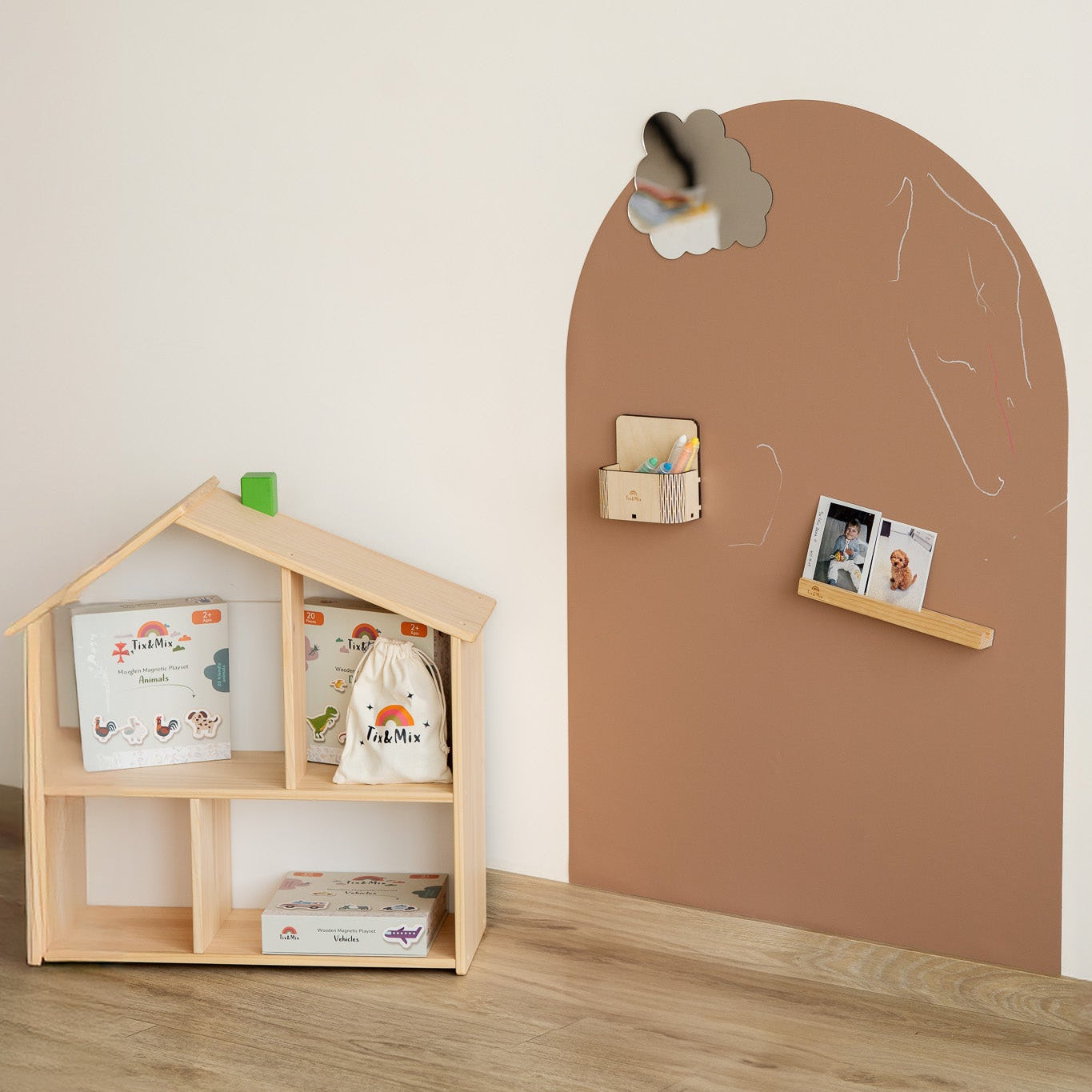 Children's room with a wooden bookshelf and a brown chalkboard wall.