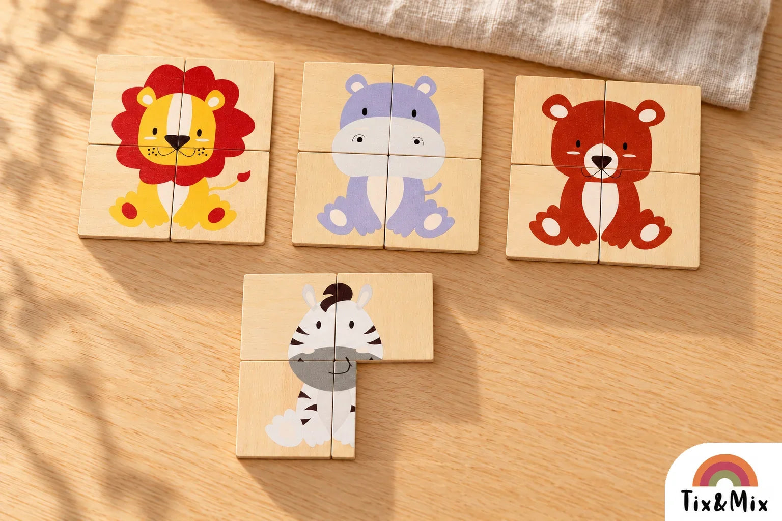 Tix&Mix wooden magnetic lion, hippo, and bear puzzles beside a zebra puzzle missing its bottom-right piece.