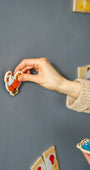 A hand placing a magnetic chicken toy on a grey magnetic wall decal.