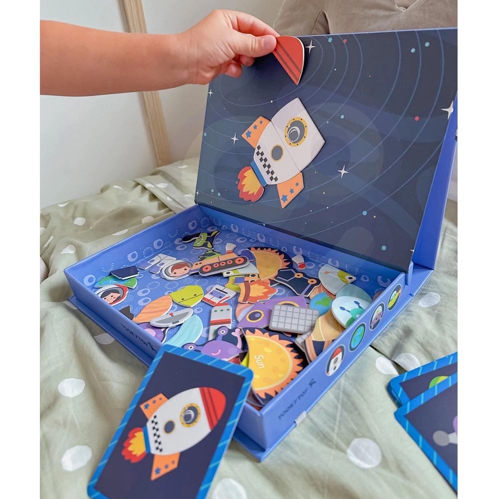 A kid playing with Tix&Mix space exploration playset in a playroom.
