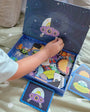A kid organizing a part of Tix&Mix space exploration toy inside the packaging box.