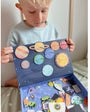 A male kid holding a Tix&Mix space exploration playset box.