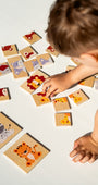 A toddler playing with Tix&Mix animal puzzle set.