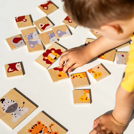 A toddler playing with Tix&Mix magnetic animals puzzle set.