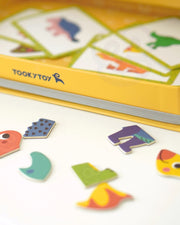 A closeup photo of a dinosaur parts and a dinosaur packaging box.