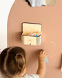 A magnetic magic box on a magnetic wall board.