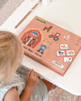 A new Tix&Mix magnetic box farm on a clean white table with a female kid on the side.