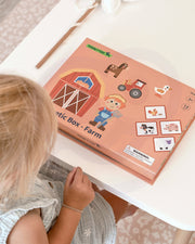 A new Tix&Mix magnetic box farm on a clean white table with a female kid on the side.