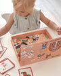 A female toddler busy playing with Tix&Mix magnetic farm toy set.