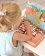 A female kid playing with Tix&Mix magnetic farm animals set.