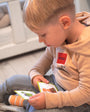 A male toddler holding Tix&Mix magnetic toys.