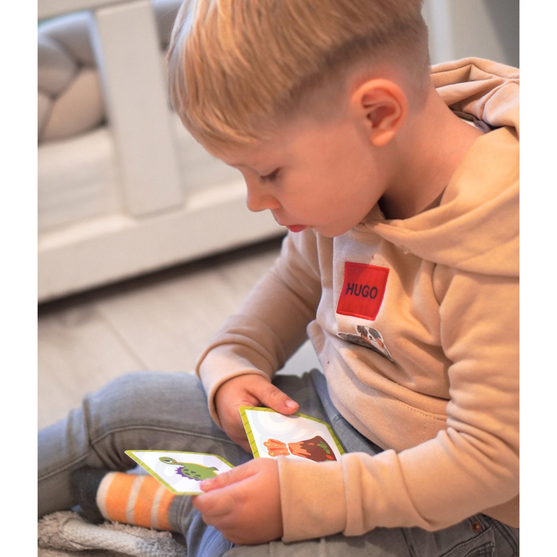 A male toddler holding Tix&Mix magnetic toys.