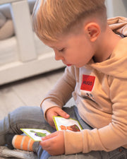 A male toddler looking at the turtle sticker.