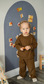 A toddler looking at the camera while playing with Tix&Mix magnetic toys.