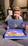 A male kid confidently looking at the camera while holding Tix&Mix space exploration toy set.