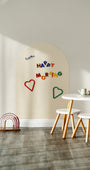 A white magnetic wall decal on a clean white wall with Tix&Mix magnetic letters placed on it.