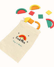 A colorful Rings and Blocks playset and a beige pouch on a white background.