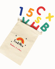 A colorful Tix&Mix wooden magnetic letters and numbers and a beige pouch.