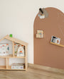Children's room with a wooden bookshelf and a brown chalkboard wall.