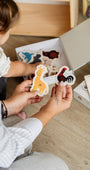 Two hands holding Tix&Mix magnetic animal toys.