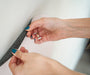 A demonstration on how to stick the Tix&Mix magnetic wall decal on the wall.