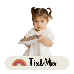 A toddler looking confident at the camera while holding a Tix&Mix premium magnetic mirror.
