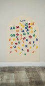 Tix&Mix magnetic numbers and letters toys attached to a white magnetic wall decal.