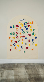 A Tix&Mix magnetic wall decal featuring wooden magnetic letters and numbers.