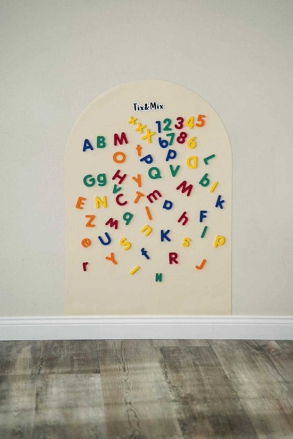 A Tix&Mix magnetic wall decal featuring wooden magnetic letters and numbers.