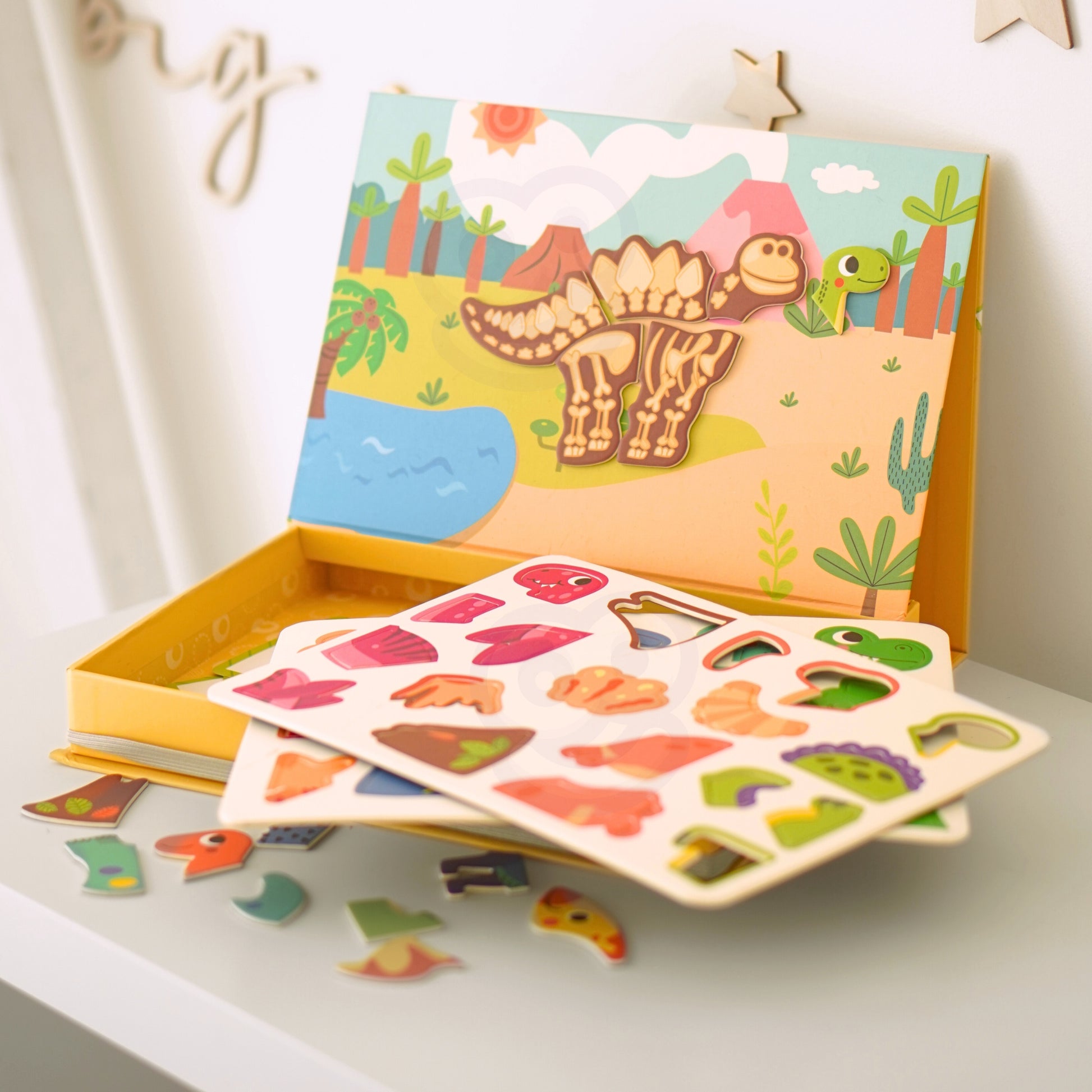 Tix & Mix Farm Discovery Set for kids with colorful dinosaur-themed magnetic pieces and activity boards in a wooden storage box.