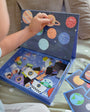 A toddler playing with Tix&Mix space exploration playset.