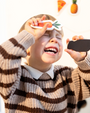 A child enjoys playing with Tix&Mix magnetic fruit toys.