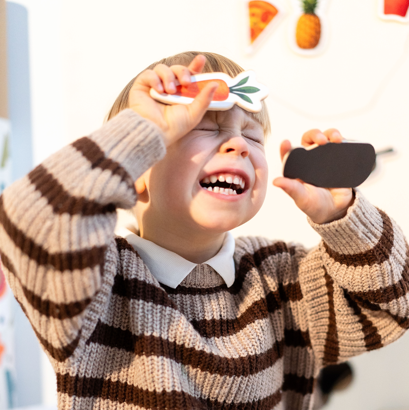 A child enjoys playing with Tix&Mix magnetic fruit toys.