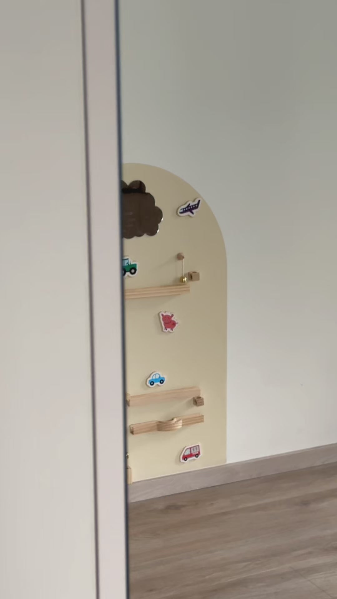 A video featuring Tix&Mix marble track on a magnetic wall decal being used by a kid and parent.